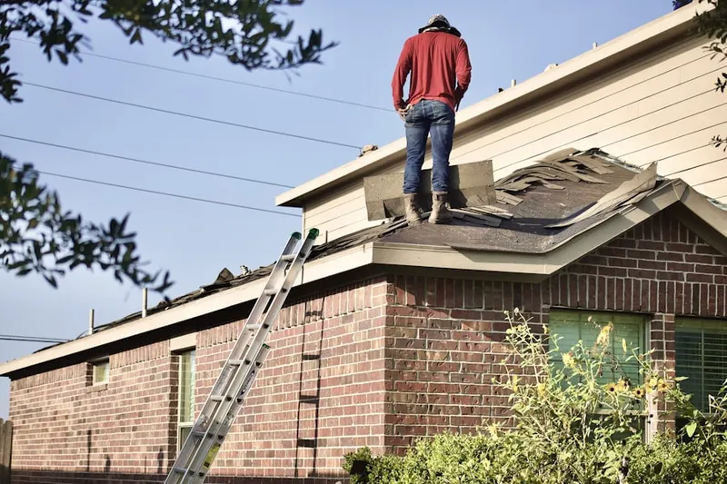 Professional roofer working on a residential roof in Fawn Lake